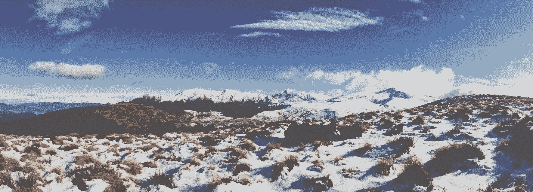The snowy Kepler Track, above the treeline, with mountains in the distance.